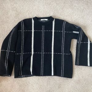 Black long sleeve sweater with white detailing